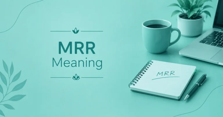 MRR Meaning displayed on a notebook beside a laptop, pen, and coffee mug on a teal workspace.
